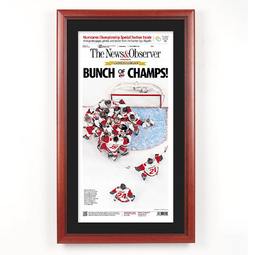 Carolina Hurricanes 2026 Stanley Cup Champions Newspaper Wood Display Frame | Shown with Cherry frame finish and Black Belt matboard